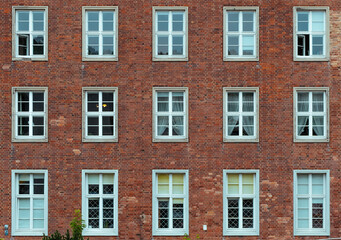 Fototapeta na wymiar White window on a red brick wall