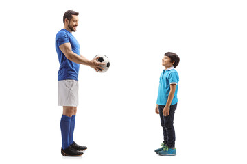 Fototapeta premium Footballer giving a soccer ball to a boy
