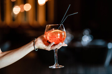 Aperol spritz in the hands of a girl. Aperol spritz. Cocktail.