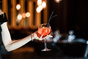 Aperol spritz in the hands of a girl. Aperol spritz. Cocktail.