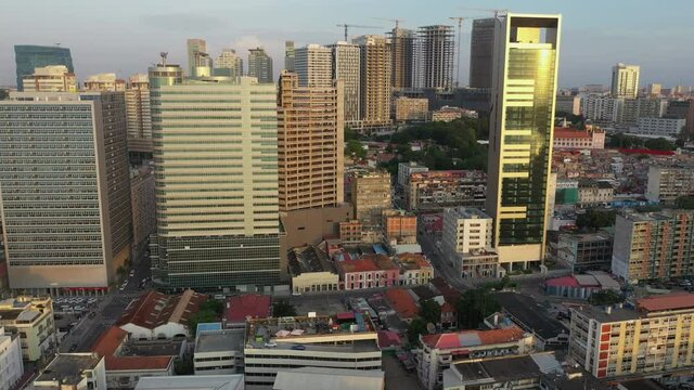 Luanda skyline from above, capital of Angola. Aerial footage, pan out during the sunset hour, part 3