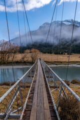Swing footbridge across the Matukituki river New Zealand
