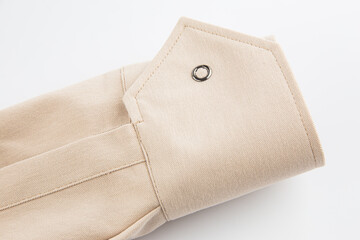sleeve detail, beige cotton fabric cuff, button closure, on a white background