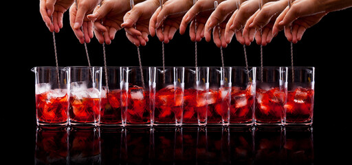 Stirring a Negroni cocktail timelapse on a black background