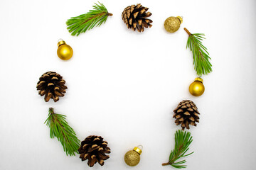 Round frame from fir branches, pine cones and Christmas balls on a white background. Congratulation, happy new year concept. Top view, flat lay, copy space.