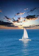 White Sailboat on Sunset Sky