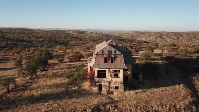 4K aerial drone video of Africa savanna hills, plains and abandoned dilapidated old colonial mansion near Neuheusis west of Windhoek in central highland Khomas Hochland of Namibia, southern Africa