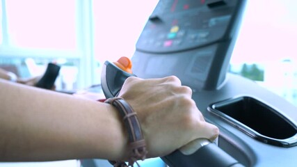 Hand woman push button for setting on treadmill