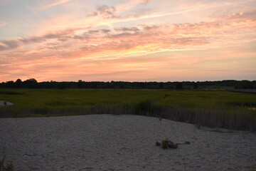 Naklejka premium sunset near sand and grass