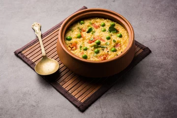 Foto op Canvas Dalia khichdi or Daliya Khichadi is a delicious one pot meal made from broken wheat and vegetables, Indian food © StockImageFactory