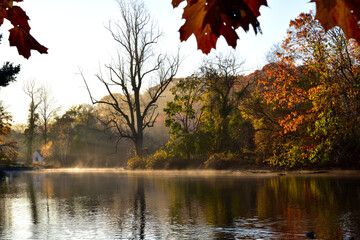 A morning view of Avalon park and preserve, Stony Brook, New York, with beautiful reflection and sun rays on the water  © Jay