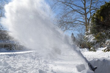 snow blown up by snow blower. 