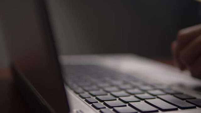 Man working and typing on laptop