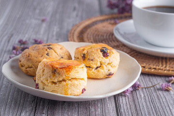 Traditional British scones and cookie with a tea cup and blurred background
