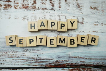 Happy September alphabet letters on wooden background