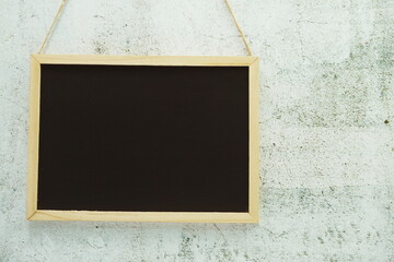 Empty black board on concrete wall texture background