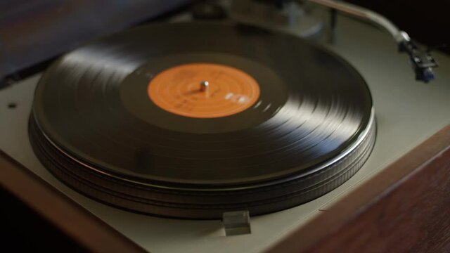 A vinyl record ends side A and gets flipped to side B