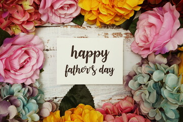 Happy Fathers day Card with colorful flowers border frame on wooden background