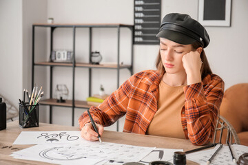 Female calligraphist working in office