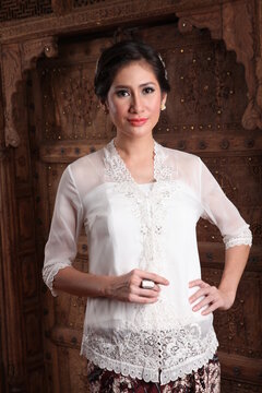 Beautiful woman wearing an elegant kebaya, kebaya is a traditional dress worn by Indonesian and Malaysian women made from gauze cloth worn with batik.