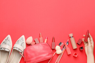 Female hand and set of decorative cosmetics on color background