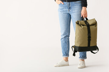 Naklejka premium Young woman with backpack on white background