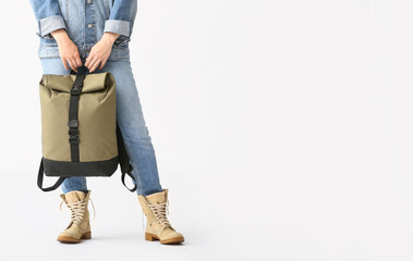 Young woman with backpack on white background
