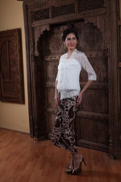 Beautiful woman wearing an elegant kebaya, kebaya is a traditional dress worn by Indonesian and Malaysian women made from gauze cloth worn with batik.