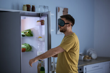 Male sleepwalker near fridge at night