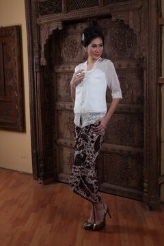 Beautiful woman wearing an elegant kebaya, kebaya is a traditional dress worn by Indonesian and Malaysian women made from gauze cloth worn with batik.