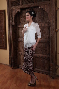 Beautiful woman wearing an elegant kebaya, kebaya is a traditional dress worn by Indonesian and Malaysian women made from gauze cloth worn with batik.