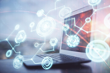 Computer on desktop with social network hologram. Double exposure. Concept of international people connections.