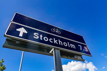 Stockholm, Sweden  A street sign for the city and bike path symbol.