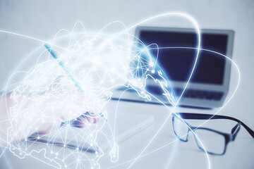 Double exposure of Man writing in notepad with business icons on background.