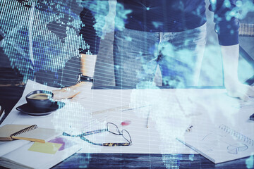 Obraz premium Double exposure of Man writing in notepad with business icons on background.