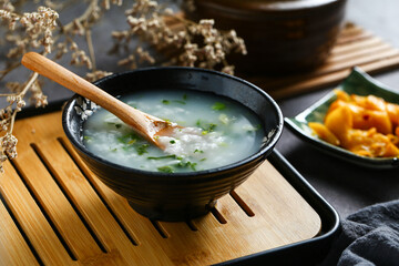 vegetable congee in black bowl