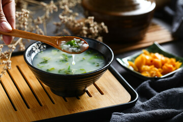 vegetable congee in black bowl