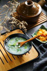 vegetable congee in black bowl
