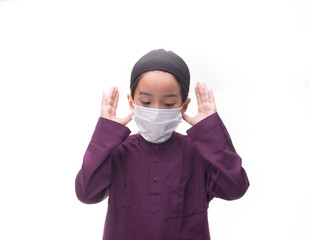 A Muslim kid with various poses isolated over white