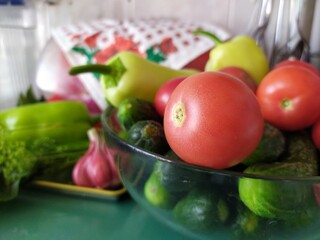 Food still life on the kitchen table pepper tomatoes cucumbers cherry plum garlic dill herbs grape leaves