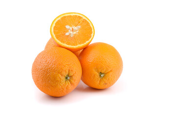 three oranthree oranges, whole and cut with splashes of juice close-up on a white background, horizontal viewges close-up on a white background, horizontal view