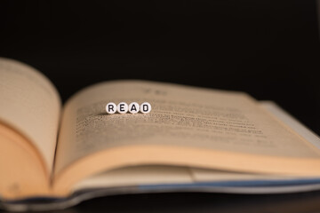 Fototapeta premium The word read on a book,selective focus with dark background