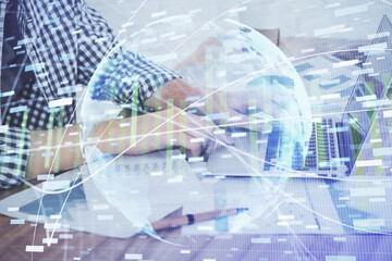 Multi exposure of businessman working on laptop on background. International business hologram in front. Concept of success.