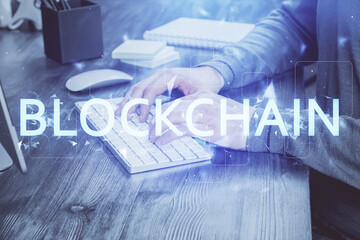Blockchain theme hud with businessman working on computer on background. Concept of crypto chain....
