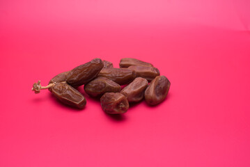dry dates fruit over red background