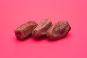 dry dates fruit over red background