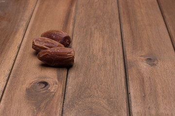 Dry dates over wooden surface