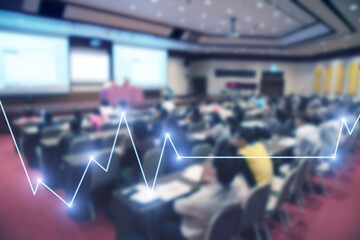 Blurred background of business people in conference hall or seminar room with Stock market or forex trading graph.
