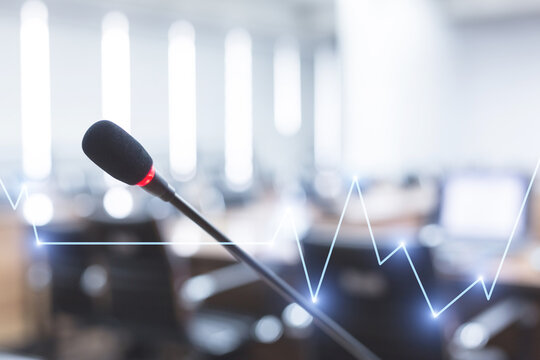 Microphone over the blurred business forum Meeting or Conference Training Learning Coaching Room Concept with Stock market or forex trading graph.