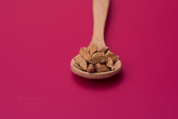 Cardamom herbs over red background